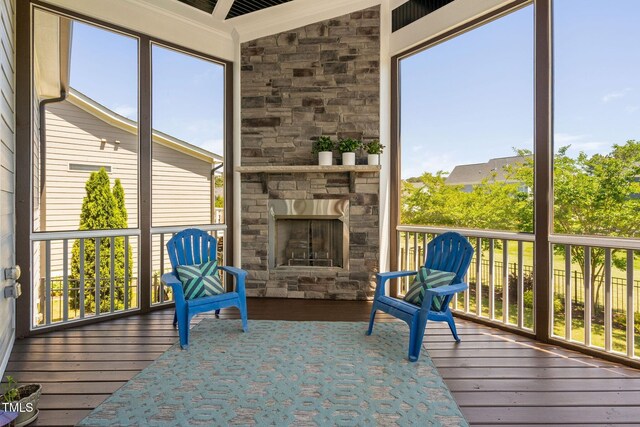 sunroom with a stone fireplace