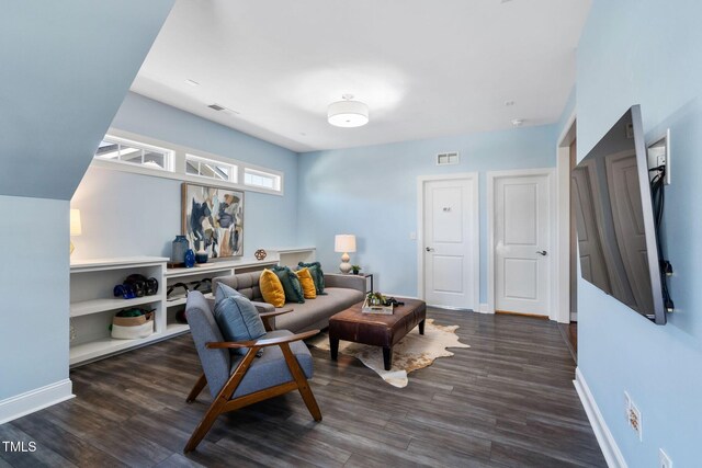 living area with wood finished floors and baseboards