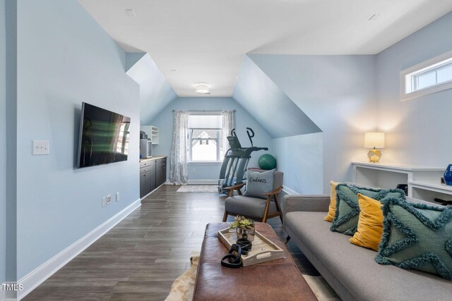 living area featuring baseboards, dark wood-style floors, and lofted ceiling
