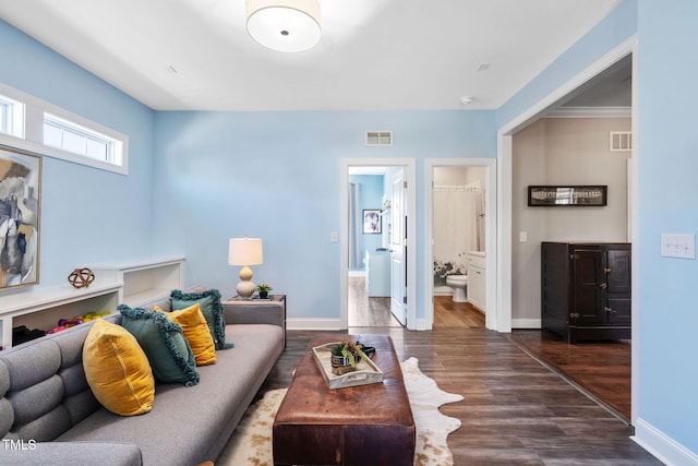 living room featuring dark wood-type flooring and baseboards