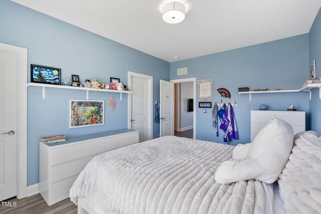 bedroom featuring wood finished floors and baseboards