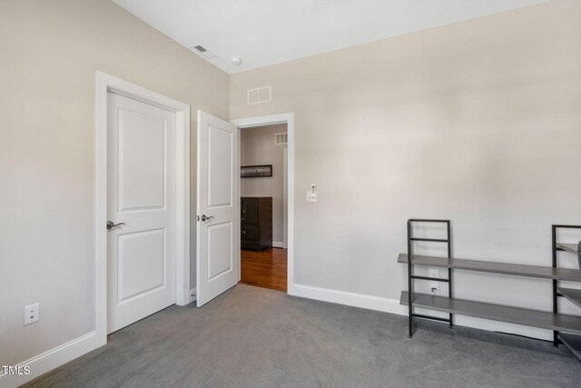 unfurnished bedroom with carpet and baseboards