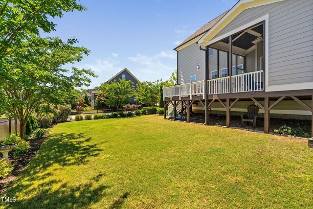 view of green lawn featuring a wooden deck