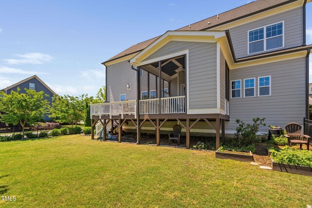 rear view of house with a wooden deck, a yard, a garden, and stairs