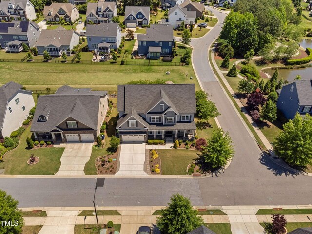 aerial perspective of suburban area featuring a nearby body of water