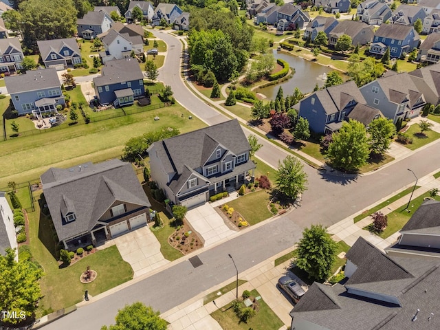 aerial perspective of suburban area with a nearby body of water