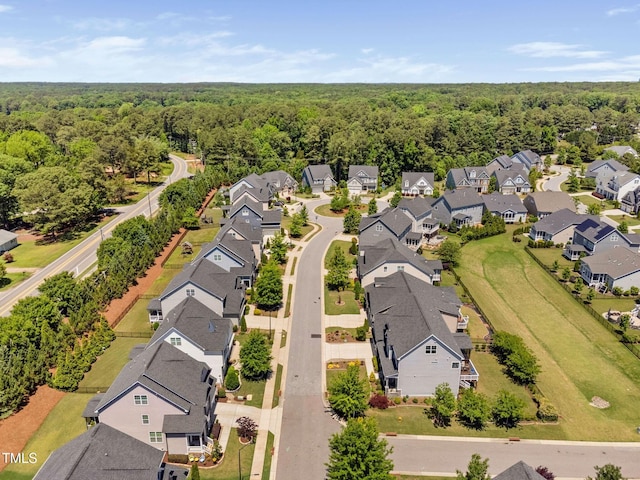 aerial perspective of suburban area with a heavily wooded area