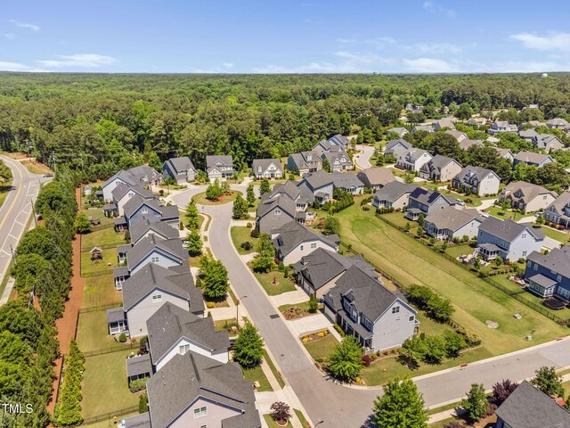 aerial view of residential area featuring a heavily wooded area