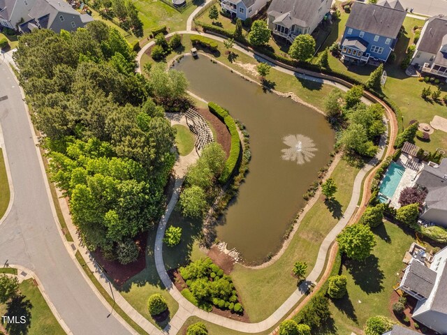 aerial perspective of suburban area with a nearby body of water