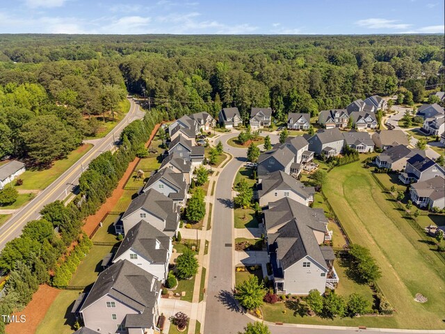aerial perspective of suburban area with a forest