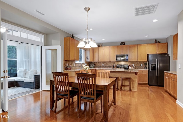 1141 Brookhill Way, Cary, NC 27519 - dining area featuring healthy amount of natural light, light wood finished floors, a chandelier, and recessed lighting