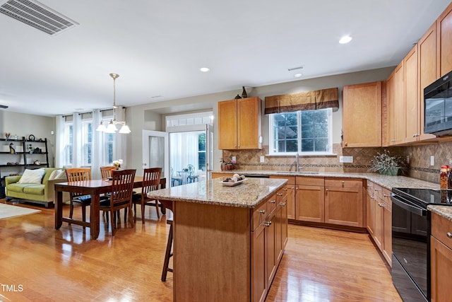 1141 Brookhill Way, Cary, NC 27519 - kitchen featuring black appliances, a sink, decorative backsplash, light wood-style flooring, and recessed lighting
