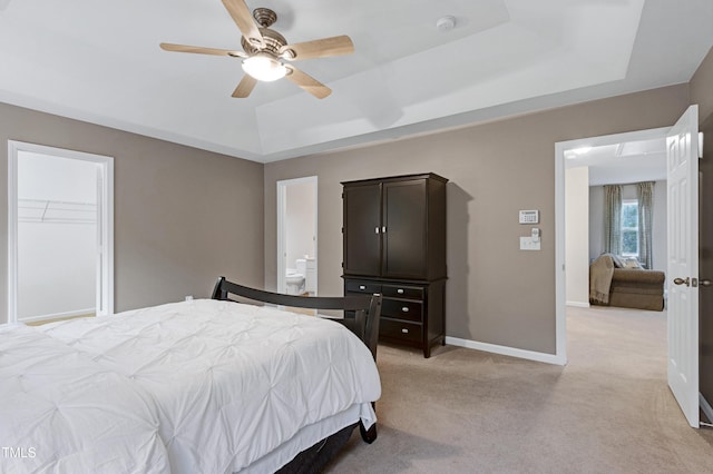 1141 Brookhill Way, Cary, NC 27519 - bedroom featuring a tray ceiling, light colored carpet, baseboards, and a ceiling fan