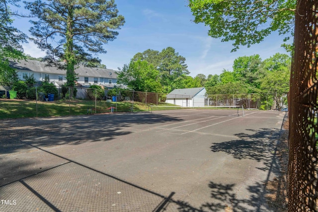 view of tennis court featuring fence