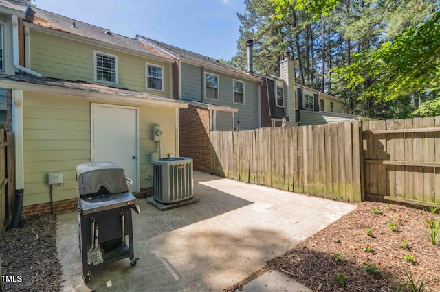 view of patio / terrace with central air condition unit, fence, and area for grilling