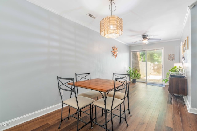 dining space featuring ceiling fan, ornamental molding, baseboards, and wood finished floors