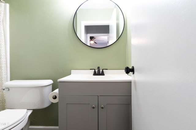 bathroom featuring vanity, ceiling fan, and toilet