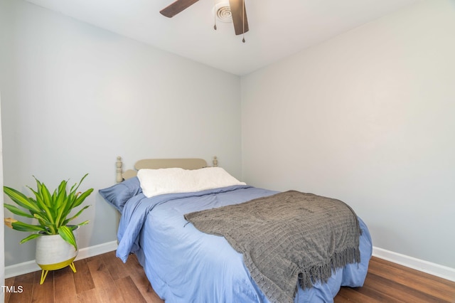 bedroom featuring wood finished floors, baseboards, and ceiling fan