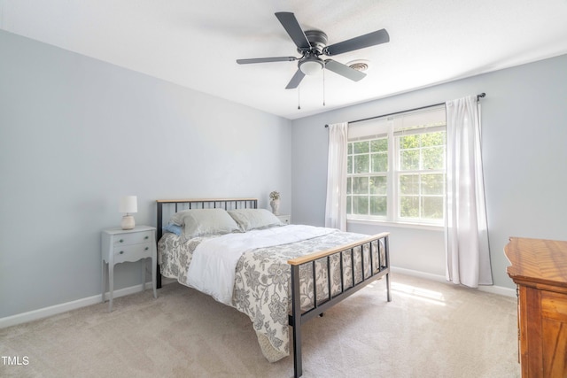 carpeted bedroom featuring baseboards and a ceiling fan