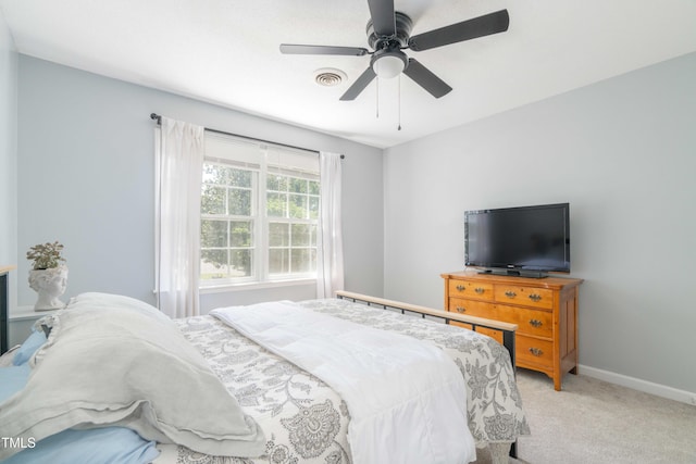 bedroom featuring light carpet, baseboards, and ceiling fan