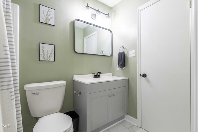 full bathroom with marble look tile flooring, toilet, vanity, baseboards, and a shower with shower curtain