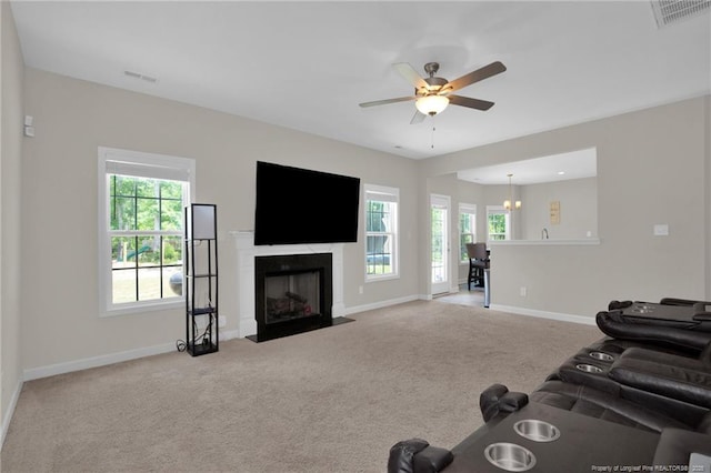 living room featuring a wealth of natural light, baseboards, and visible vents