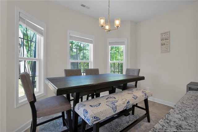 dining area with a notable chandelier, baseboards, and visible vents