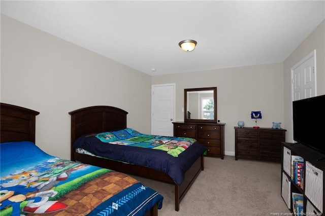 bedroom featuring baseboards and light carpet