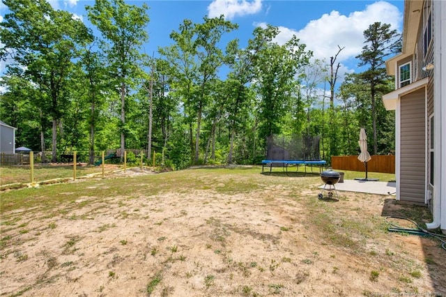 view of yard with a fenced backyard and a trampoline