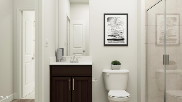 full bath with toilet, vanity, and a stall shower