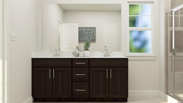 full bath with a stall shower, baseboards, double vanity, and a sink
