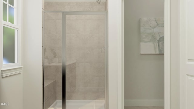 full bath with a stall shower and baseboards