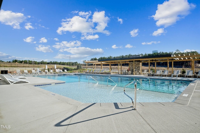 community pool with a patio and fence