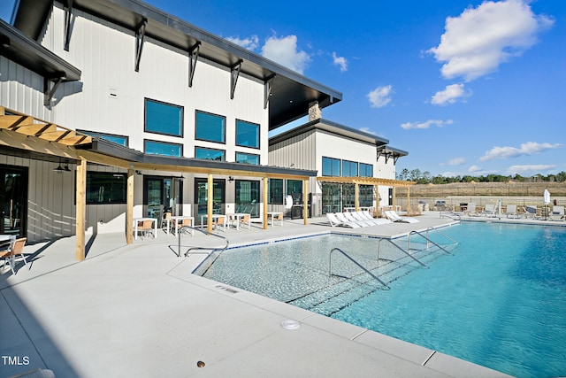 community pool with a patio area and fence