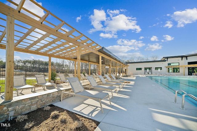 pool with a patio area, a pergola, and fence