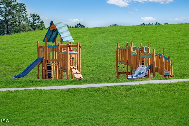 community jungle gym with a yard