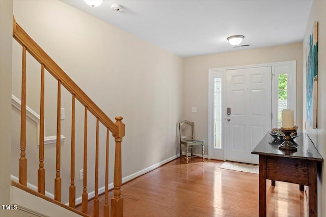 11925 Field Towne Ln, Raleigh, NC 27614 - entryway featuring wood finished floors, stairs, and baseboards