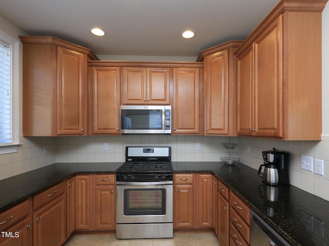 kitchen with stainless steel appliances, dark stone countertops, tasteful backsplash, and recessed lighting
