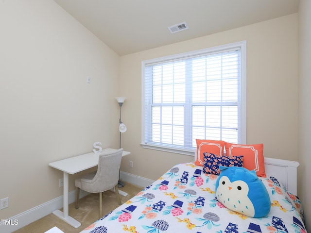carpeted bedroom featuring multiple windows, lofted ceiling, and baseboards