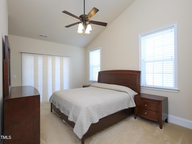 bedroom with light carpet, vaulted ceiling, baseboards, and a ceiling fan