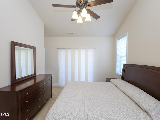 bedroom featuring vaulted ceiling, light colored carpet, and a ceiling fan
