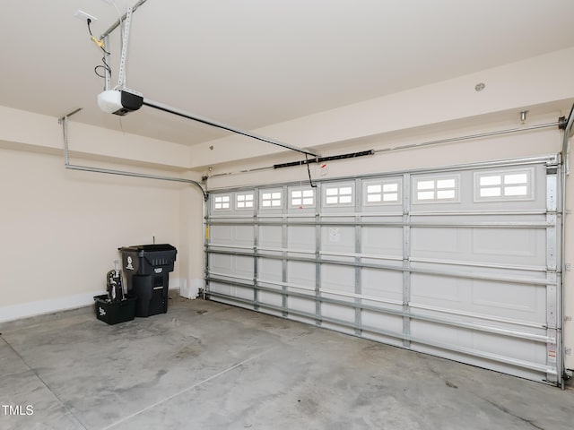 garage featuring baseboards and a garage door opener