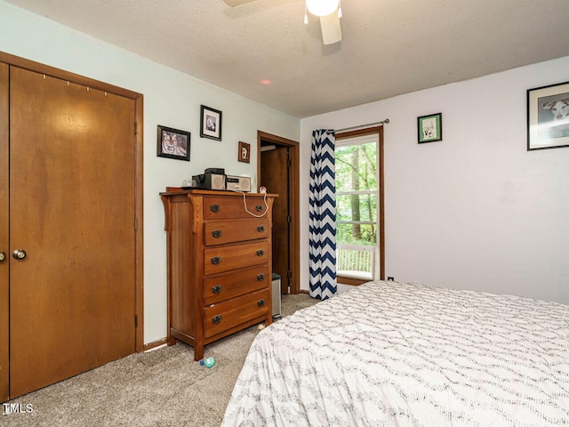 bedroom with light carpet, baseboards, and a ceiling fan