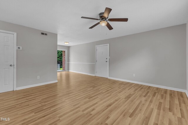 unfurnished living room with a ceiling fan, light wood-style floors, and baseboards