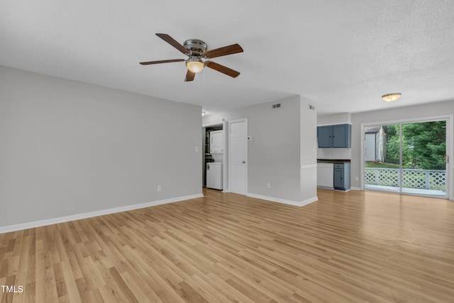 unfurnished living room featuring light wood-style flooring, a ceiling fan, and baseboards