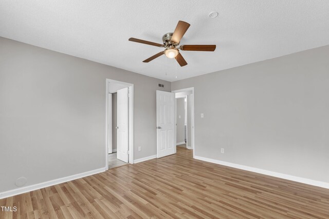 unfurnished bedroom with light wood-style flooring, baseboards, and ceiling fan