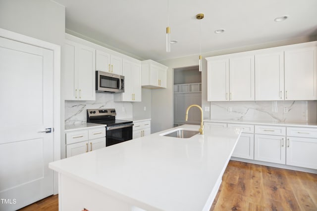 509 Olive Branch Rd, Durham, NC 27703 - kitchen with stainless steel appliances, a sink, white cabinets, backsplash, and light countertops