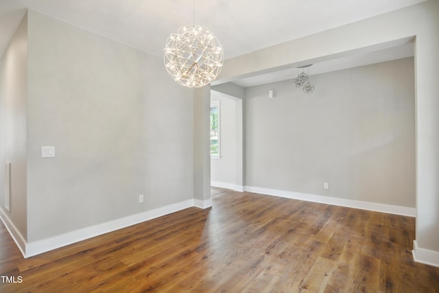509 Olive Branch Rd, Durham, NC 27703 - empty room with a chandelier, wood finished floors, and baseboards