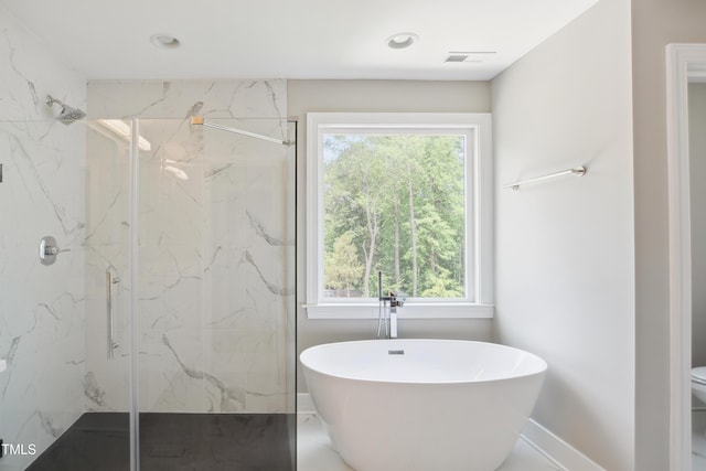 509 Olive Branch Rd, Durham, NC 27703 - full bathroom with a marble finish shower, healthy amount of natural light, a freestanding bath, baseboards, and recessed lighting