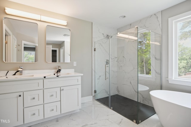 509 Olive Branch Rd, Durham, NC 27703 - bathroom featuring marble tiled flooring, a marble finish shower, double vanity, a freestanding bath, and baseboards